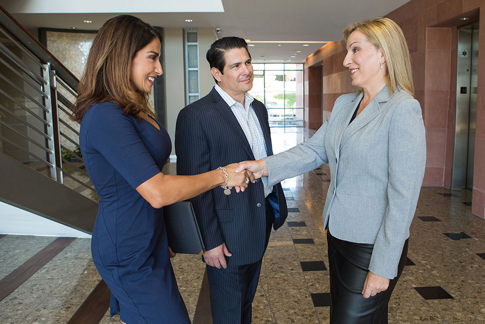 Hiring a business lawyer, image of Silvina Tondini being hired by a new client and shaking their hand