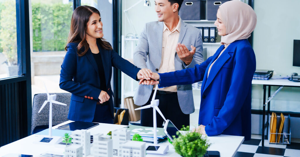 Business Immigration Visas, image of 3 people working and showing a project together.